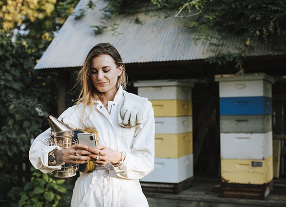 Beekeeper texting on her phone