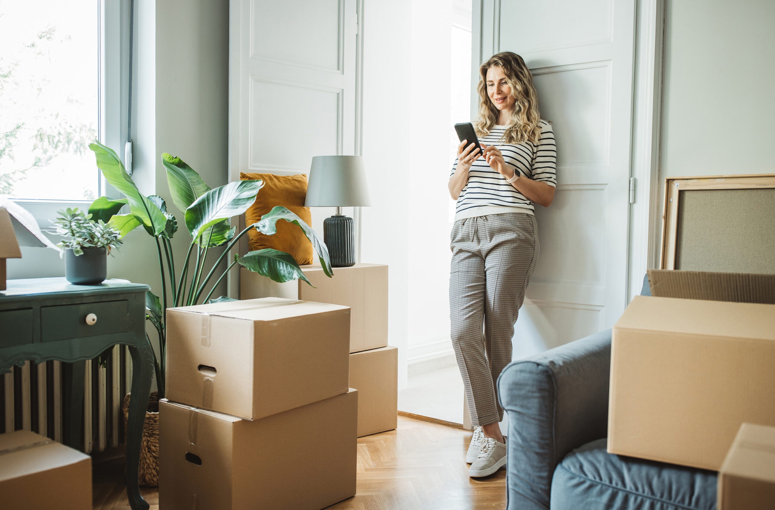 Mature woman with Moving Boxes in New Home